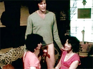 Two hairy seventies ladies sharing a big stiff cock orally