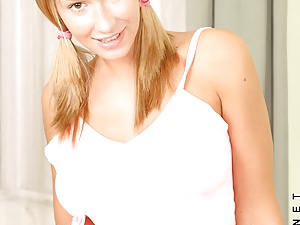 Hottie amber squeezes her perfect tits together between her arms in the kitchen